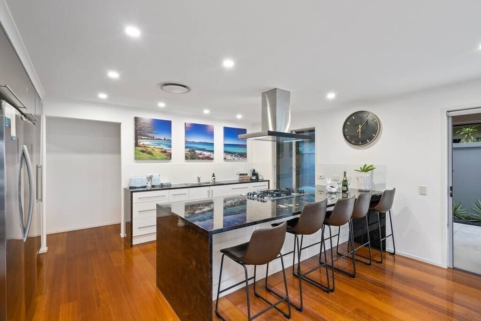 Bar seating, bench space, cooktop, oven and fridge suit longer Gold Coast stays.