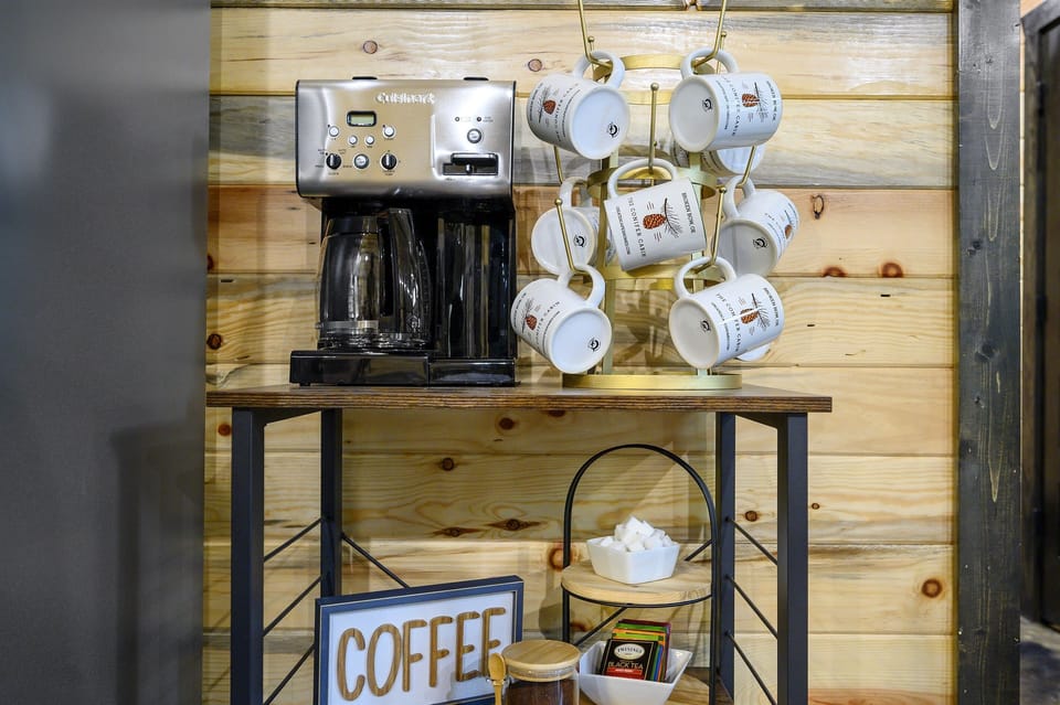 Your morning just got easier—fresh coffee, tea, and all the fixings are ready and waiting at the cozy cabin coffee bar.