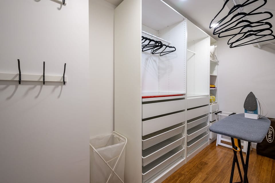 The walk in closet offers plenty of clothes storage and an iron with ironing board.