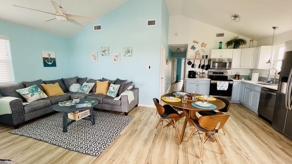 Open concept living/dining area with lovely beach decor  