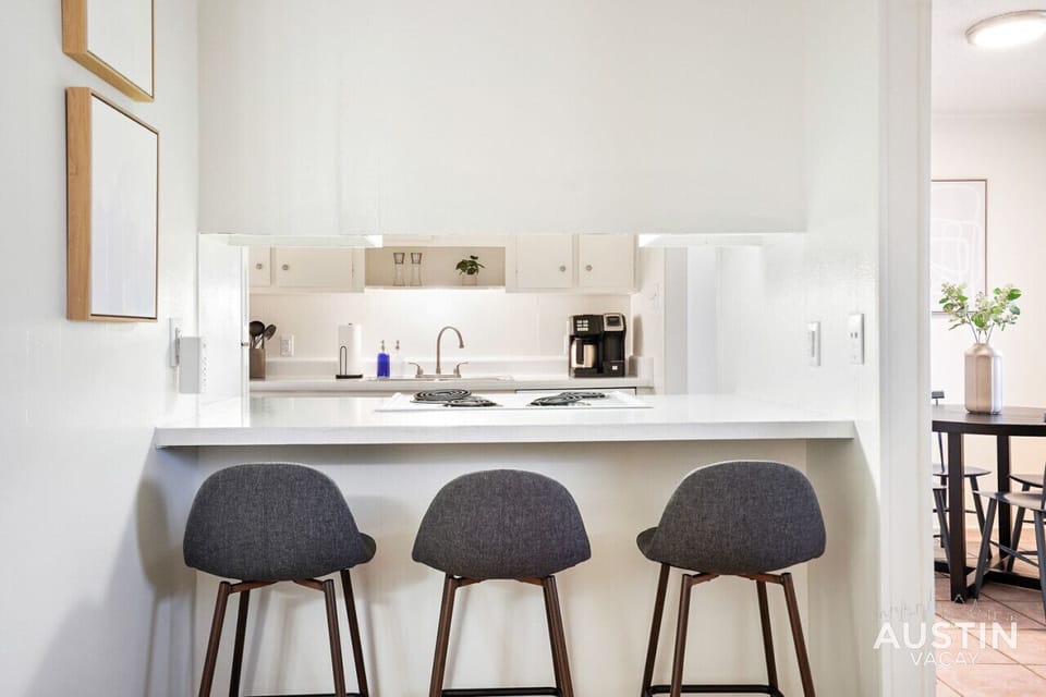 Full kitchen with all the essentials and comfortable bar seating