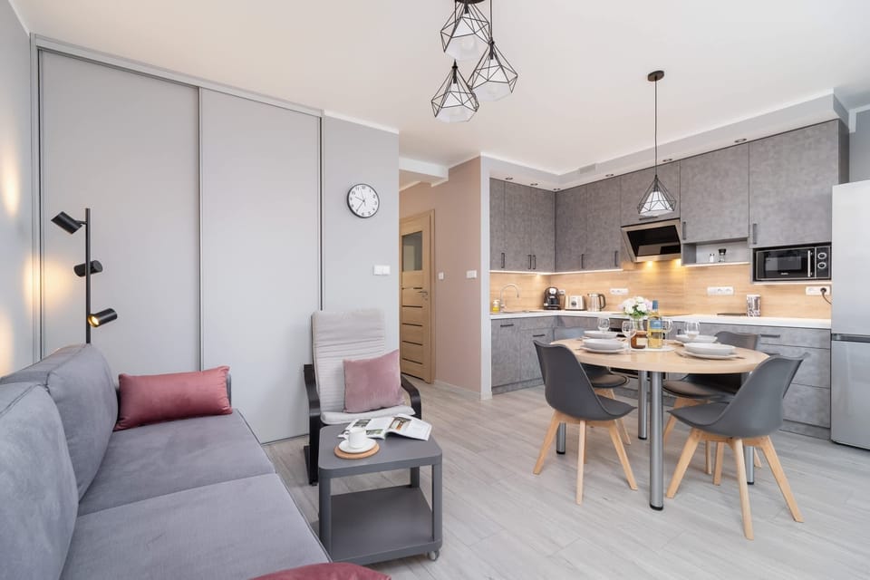 A wide view of the open-plan living and dining area, showcasing a contemporary design.
