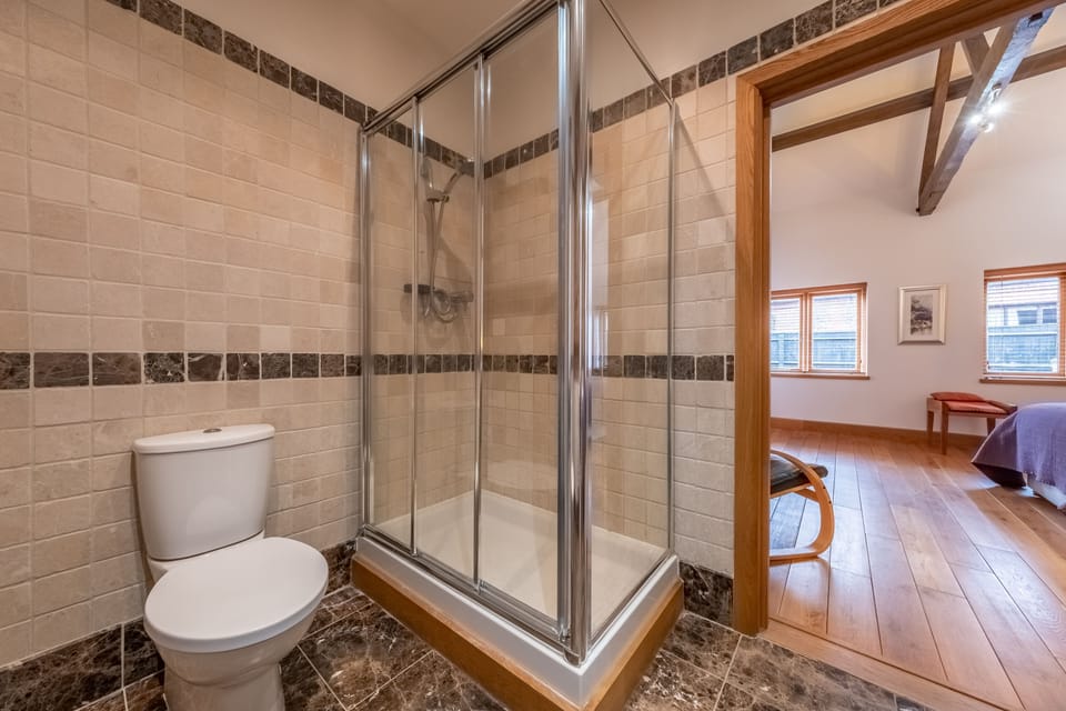 Ground floor: Master en-suite with large shower, wash basin and WC