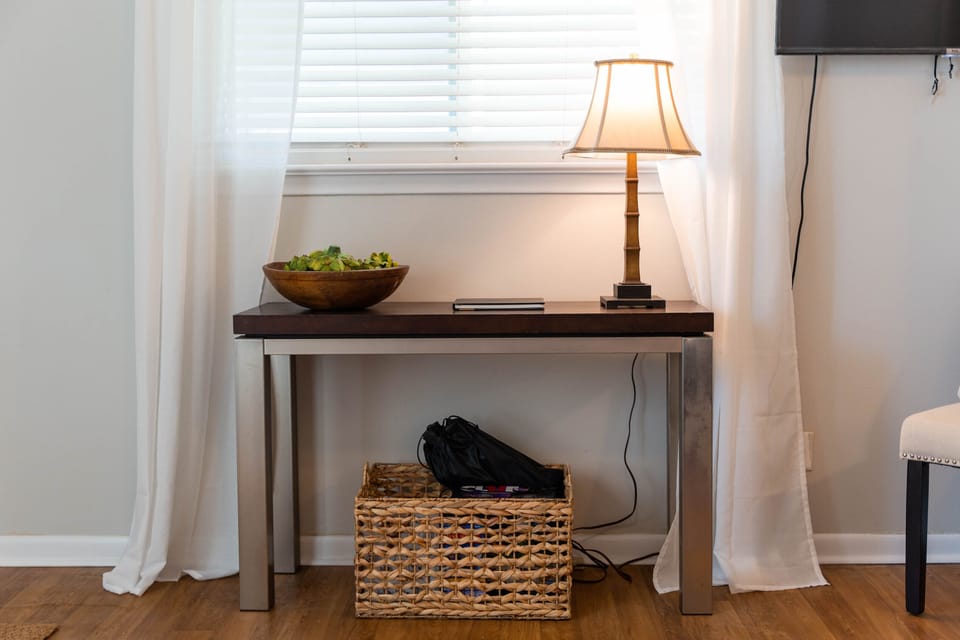 A basket of games and pickleball rackets
