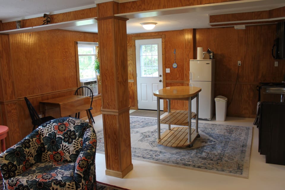 View of kitchen and entryway from standing in living room.
