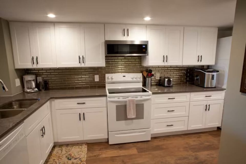 Fully stocked with dining ware. Coffee pot, toaster, and microwave. 