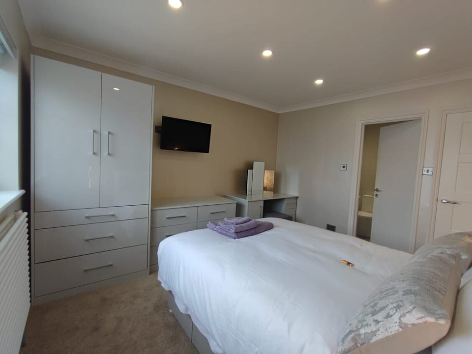 Bedroom 2 with double bed and a Smart TV and adjoining bathroom