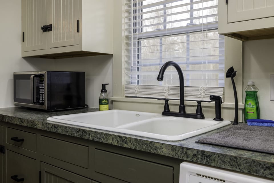 Kitchen with freshly painted cabinets and new hardware.