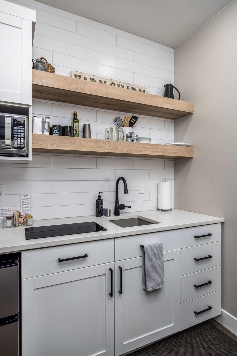 Kitchenette with 2-burner stovetop, mini fridge, and microwave