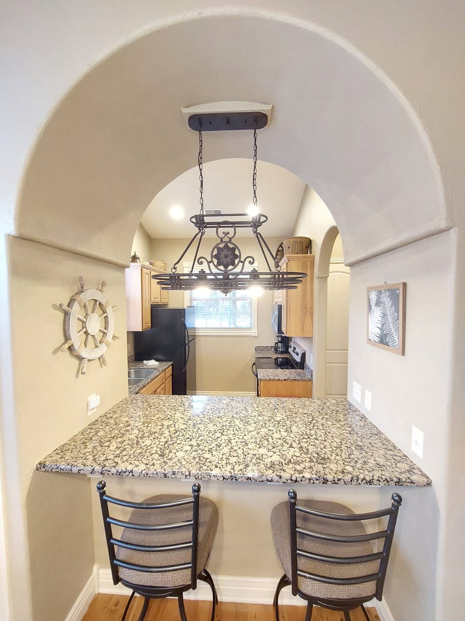 Breakfast bar, tall chairs, gorgeous lighting and decor!