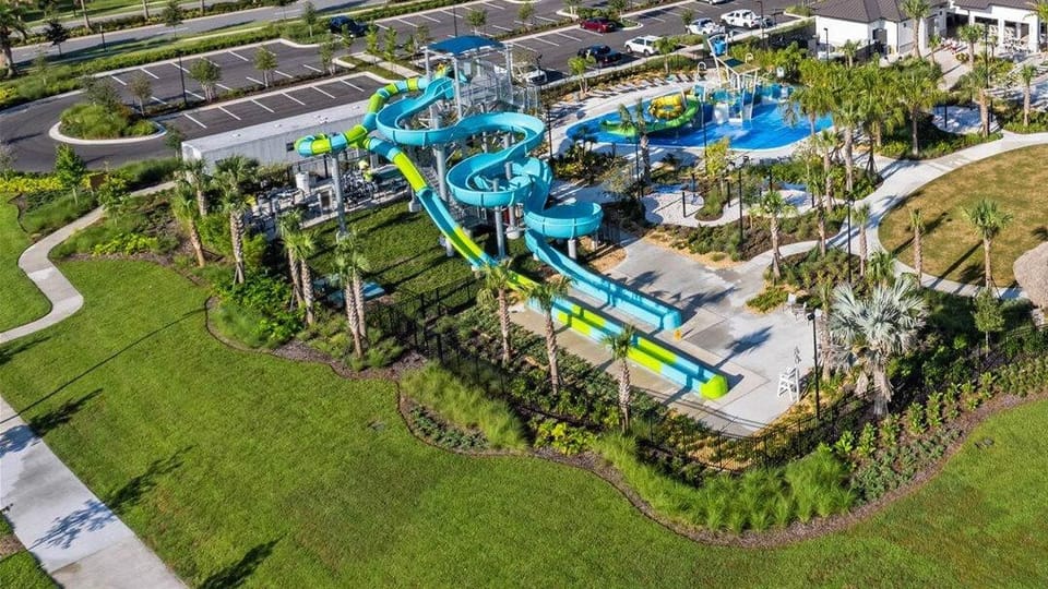 Just a hop, skip & a jump from SuperVilla! Retreat Clubhouse has mini golf, tall slides, a splash pad, bar & more—fun awaits!