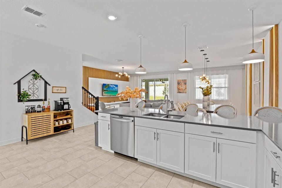 Enjoy a spacious and stylish living area with a cozy dining table and a fully equipped kitchen. Indulge in a cup of coffee from the bar and relax in comfort.