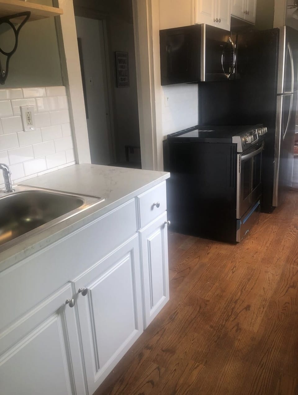 Kitchen equipped with oven, stovetop, microwave, refrigerator, essentials, etc