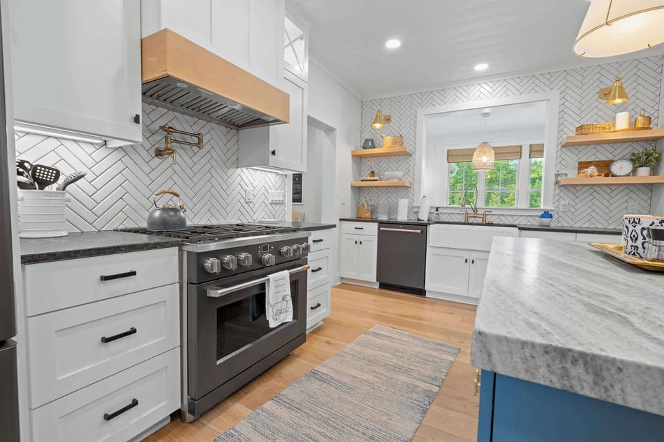 Large gas range, pot filler, kettle, and well supplied kitchen