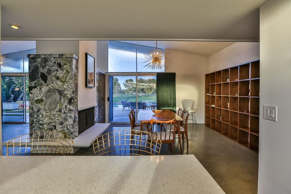 Kitchen looking into dining room and living room, both with golf course views.