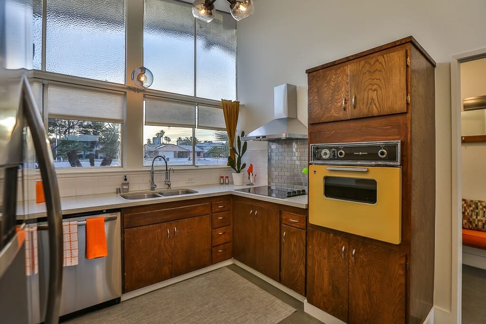 Full service kitchen with fridge, dishwasher, microwave, oven & cooktop.
