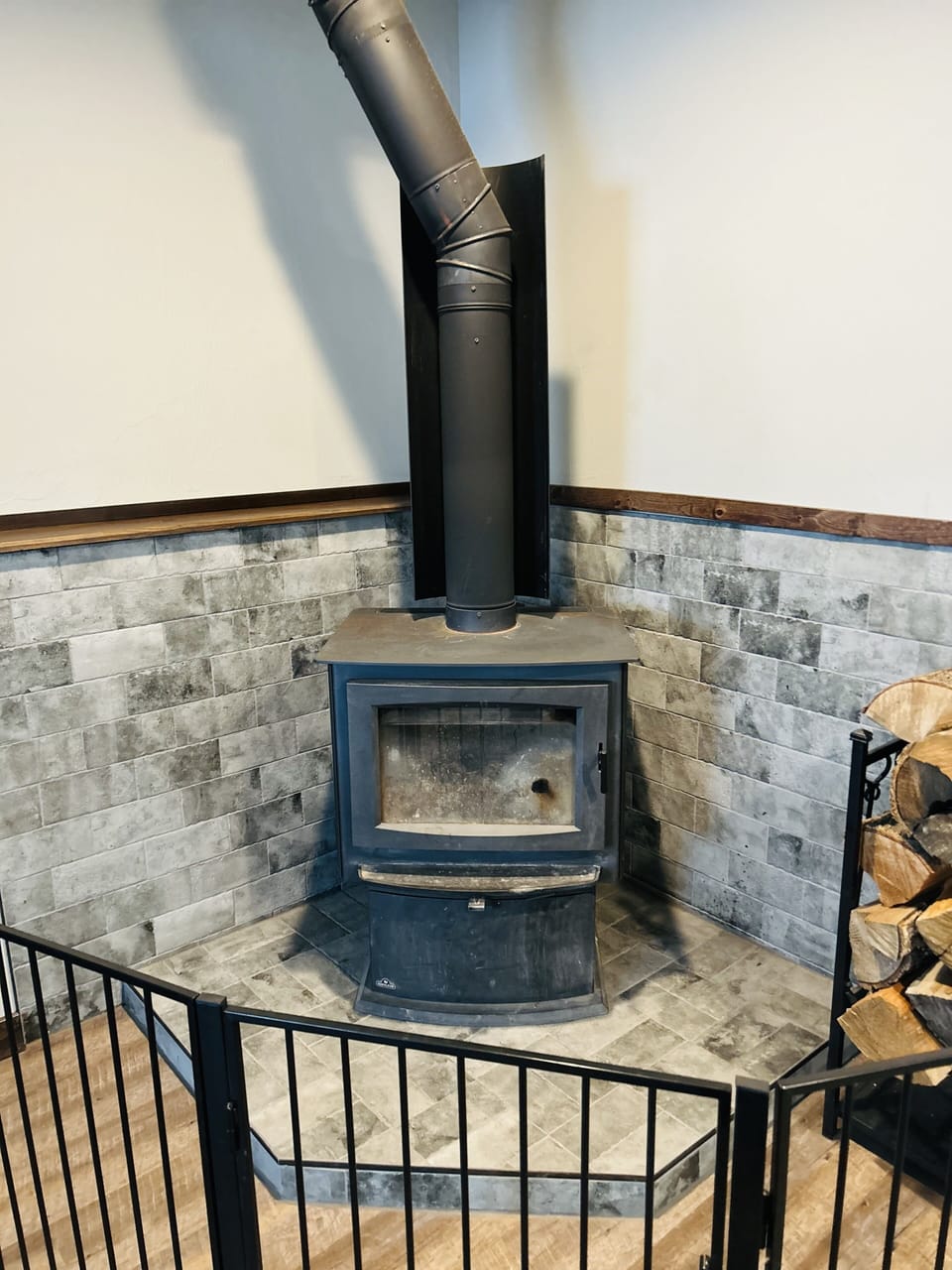 Wood fire place with toddler gate.