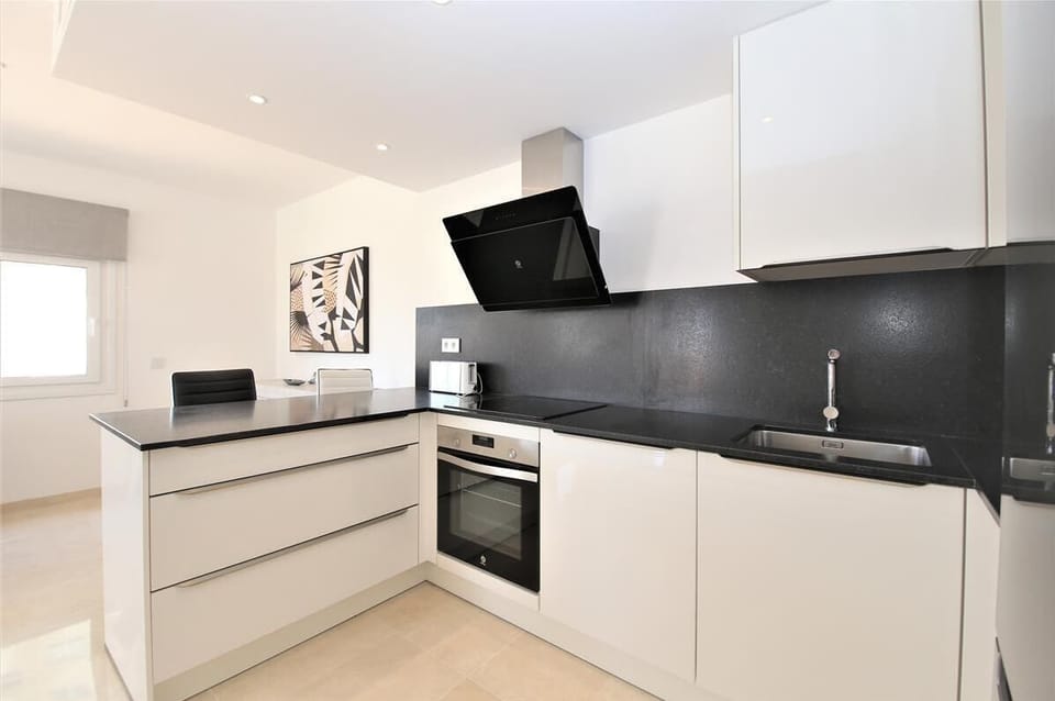 Modern open kitchen is fully equipped with all the appliances