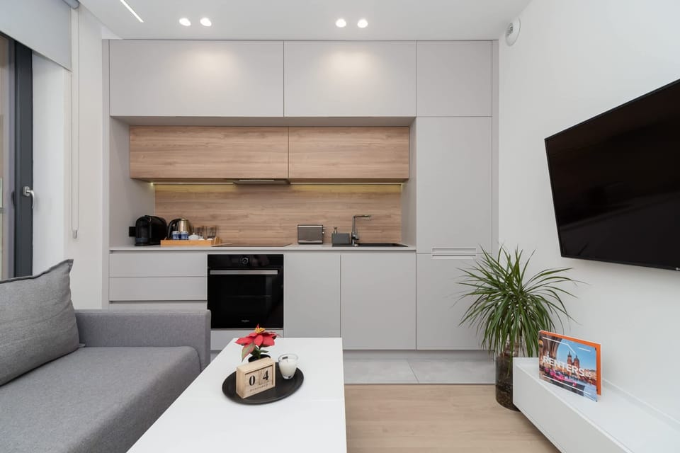 A kitchen area with built-in appliances, a wooden countertop, and a cozy dining space.
