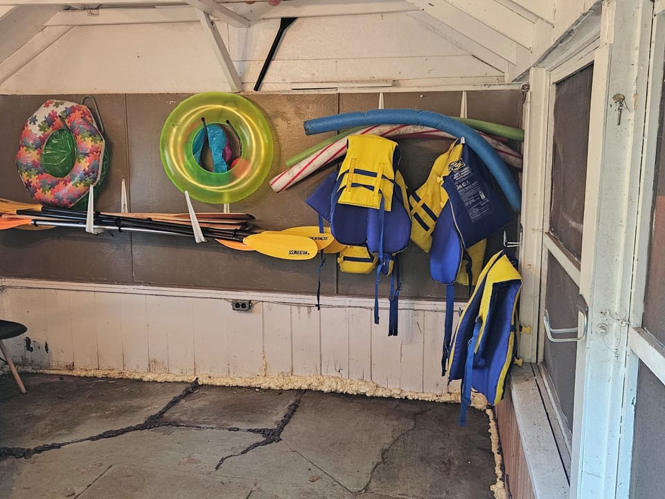 Shed where life jackets, outdoor games & patio cushions & extra chairs etc.