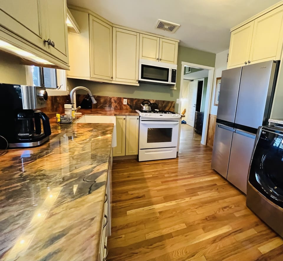 Fully stocked kitchen with gas range, microwave and toddler dishes.