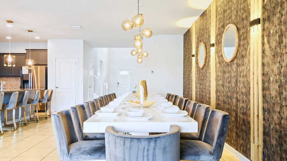 Luxurious dining area with seating for 20, elegant lighting, and designer finishes.
