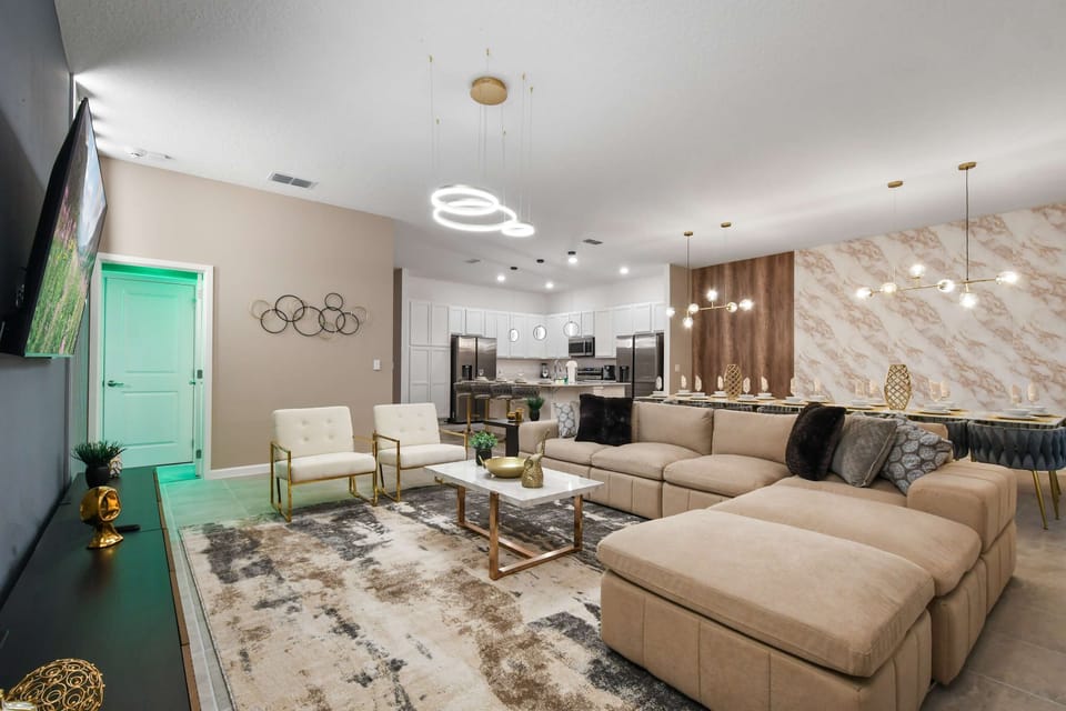 Chic open-plan space with gourmet kitchen, elegant dining, and cozy lounge area
