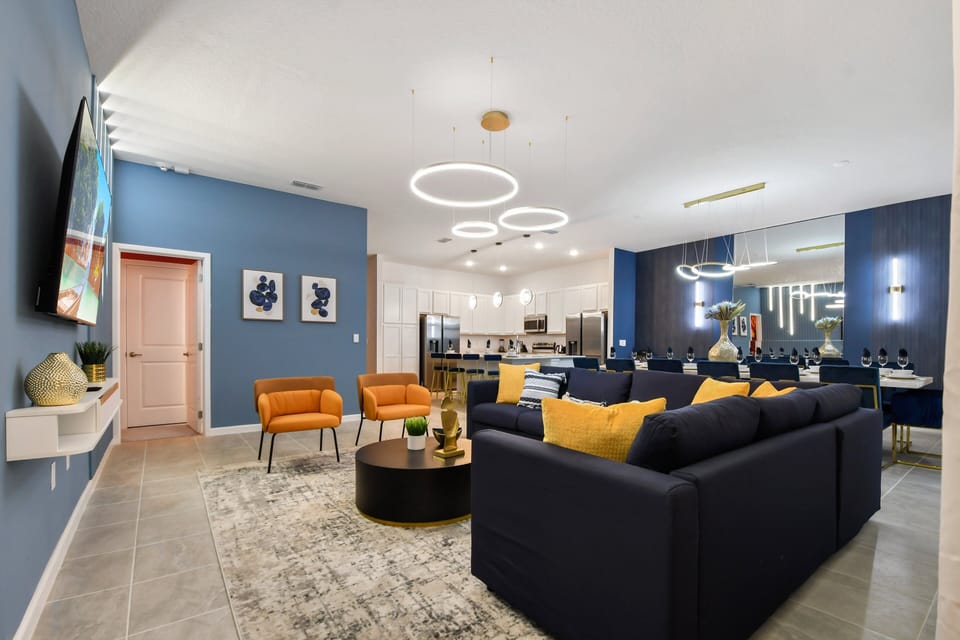 Elegant open-concept space with modern kitchen, cozy seating, and chic lighting!