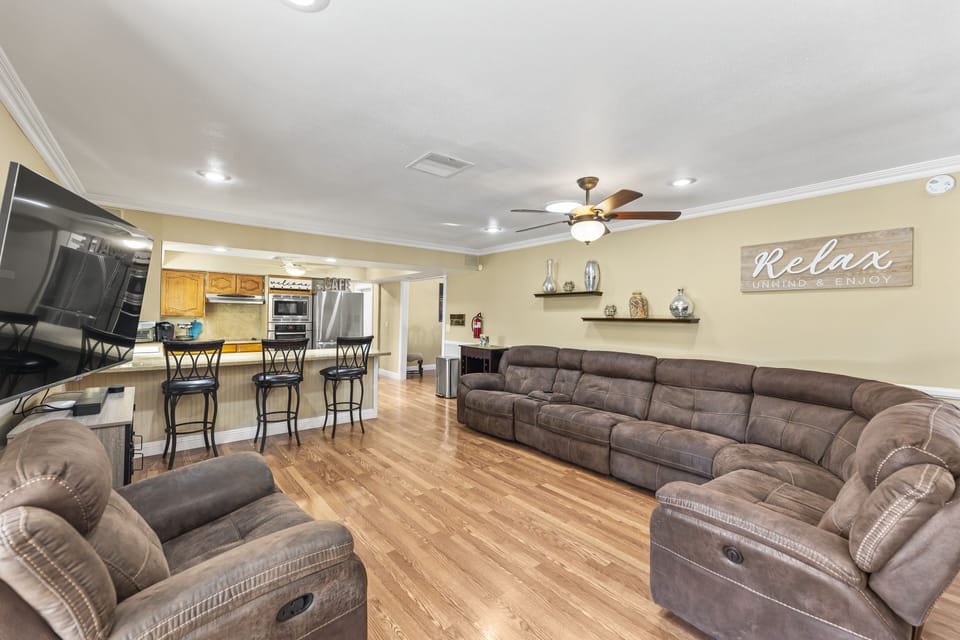 The living room is right off of the kitchen / island seating 
