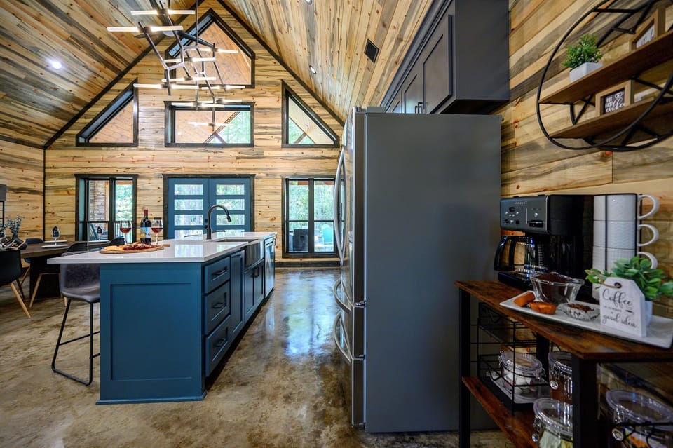 This open-concept kitchen and living area blends modern style with rustic charm, perfect for gathering, dining, and making memories together.