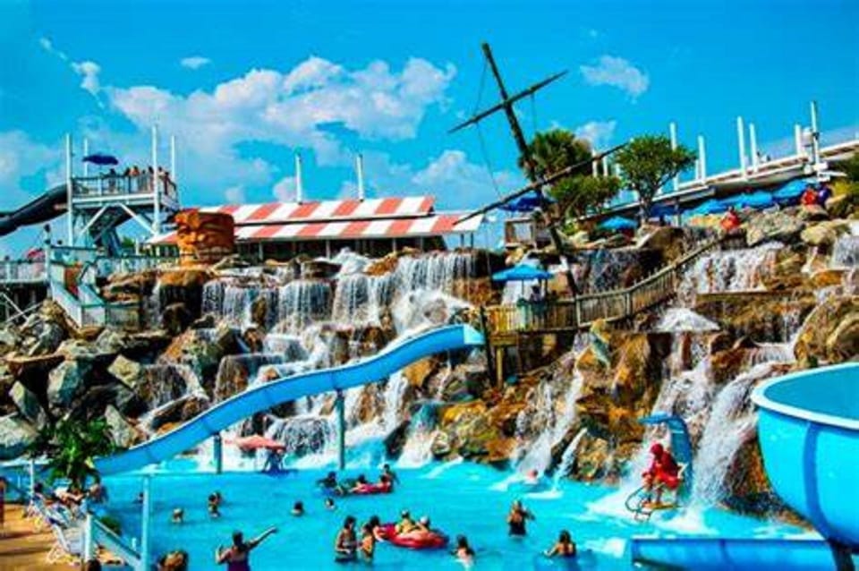 Thrilling water park with cascading waterfalls, slides, and swimming pools creates the perfect family adventure destination.