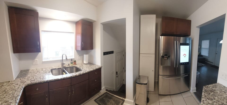 Kitchen leads to back entrance and dining room.

