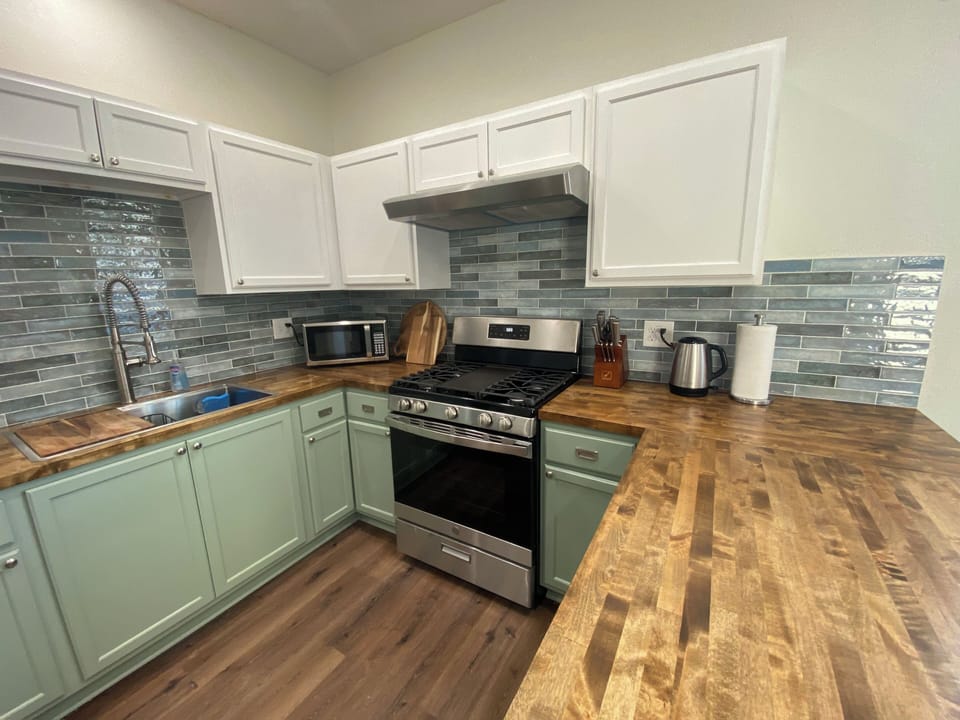 Fully equipped kitchen with new 5 burner gas oven perfect for culinary delights