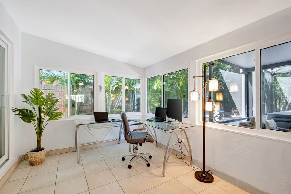 Office area with computer desk, office chair, monitor, keyboard and mouse.