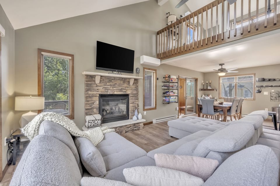 Living Room with Sofa-bed, smart TV, electric fireplace, books, board games