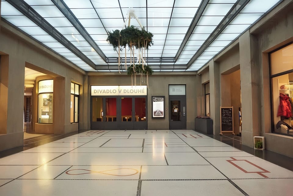 located in a passage full of restaurants,  shops and bistros
