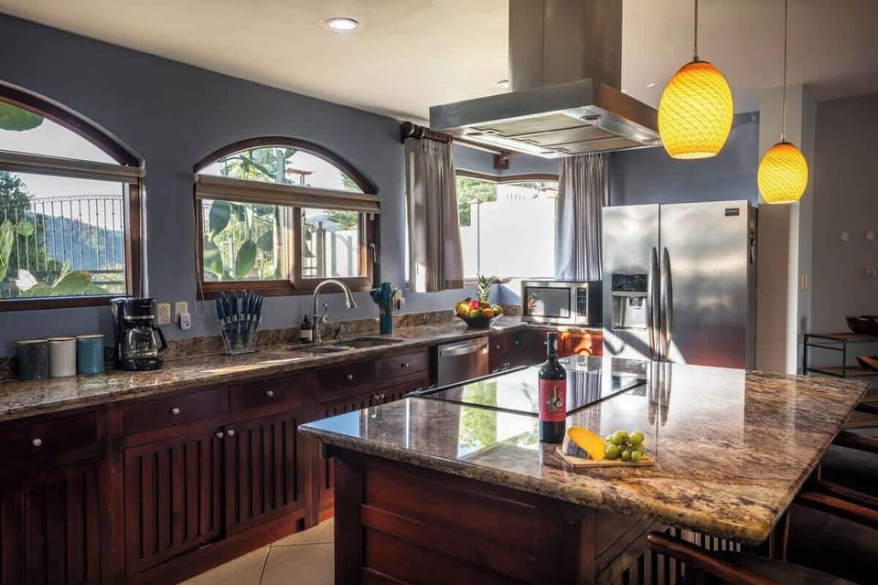 Fully equipped gourmet kitchen with granite countertops and modern appliances.