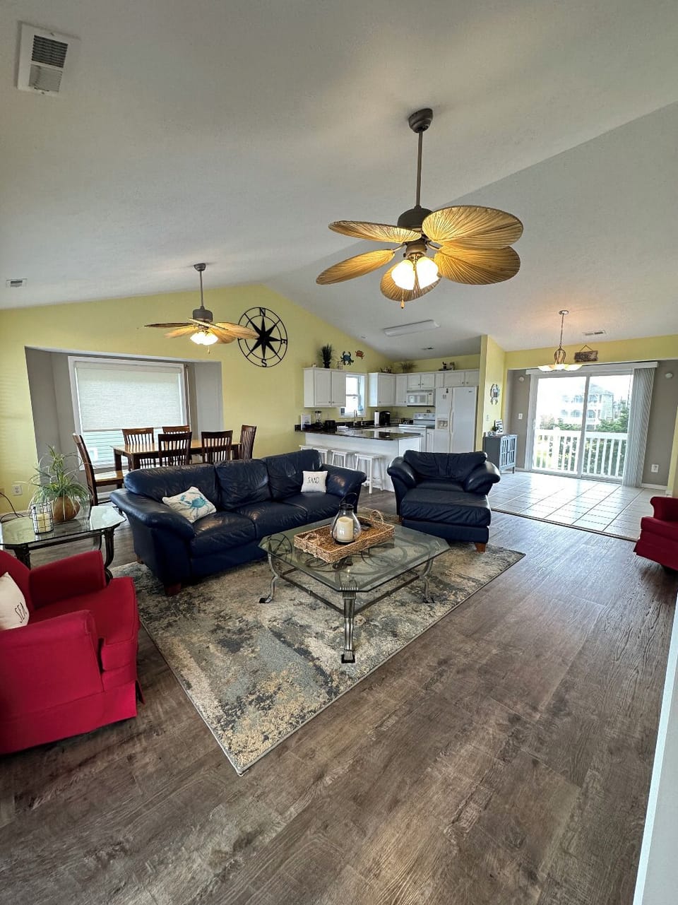 Family room with a comfy couch, oversize chair and two additional swivel chairs.