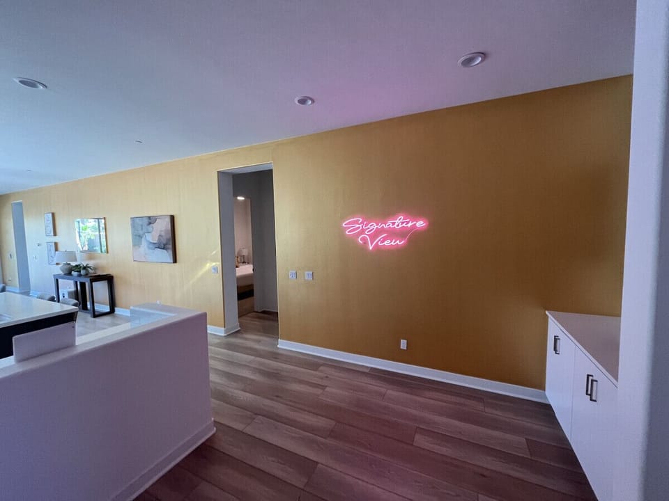 Entry space w/ bold accent wall & open layout ready to personalize your stay