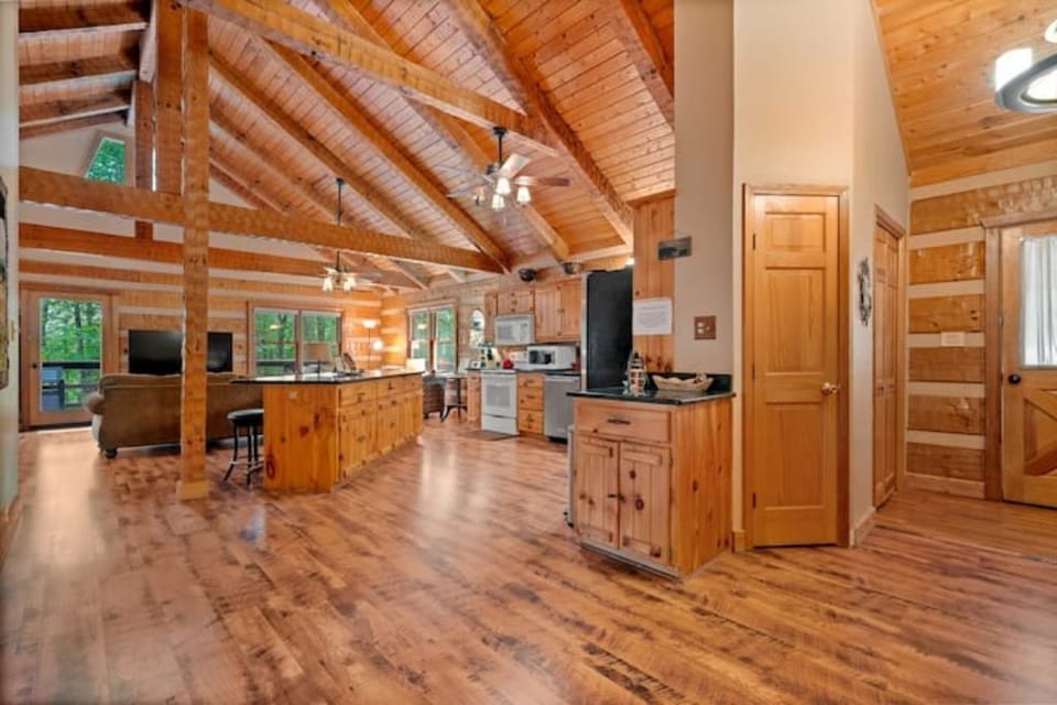 View of front door  right, open kitchen and living areas
. Cathedral ceilings. 