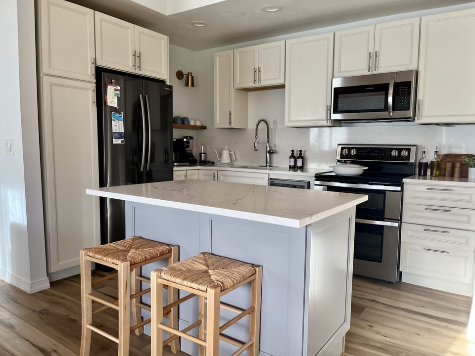 Kitchen area with spacious island with built in pull-out double garbage bins.