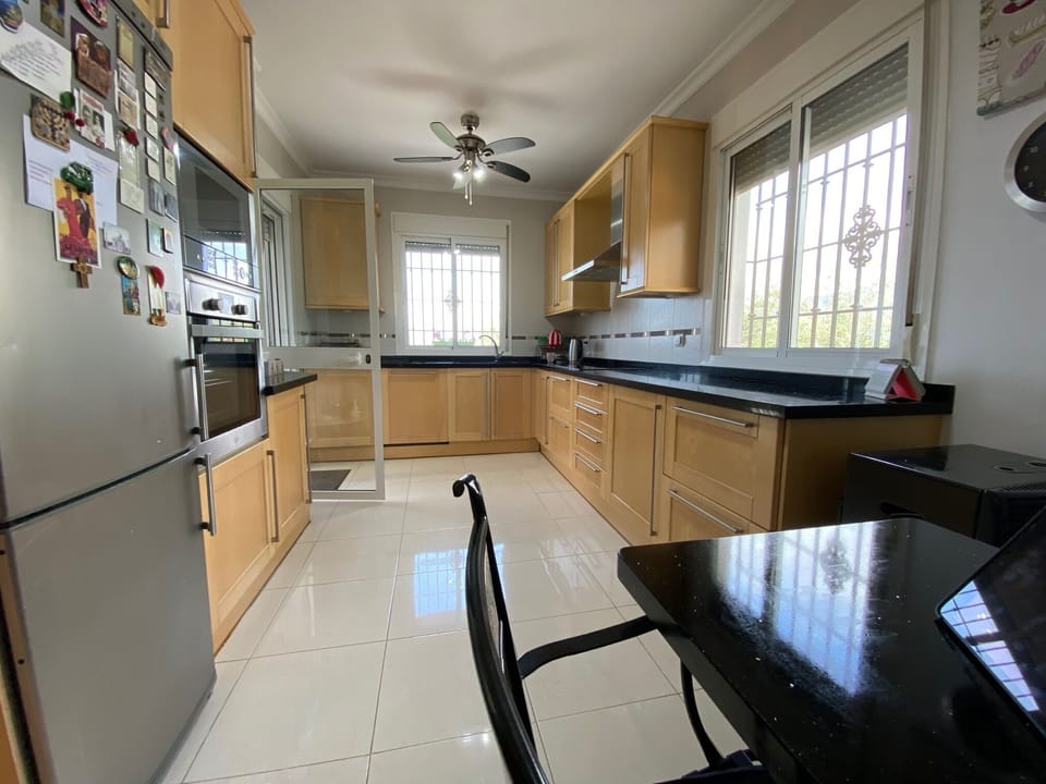 A fully equipped kitchen featuring a comprehensive range of appliances
