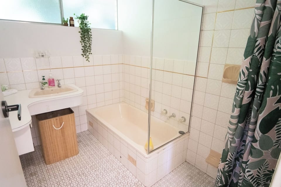 The main bathroom is centrally located on the lower level, providing easy access from all four additional bedrooms.  It includes a full-size shower and bathtub—ideal for winding down after a day at the beach or pool