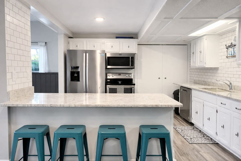 Full kitchen with a breakfast bar