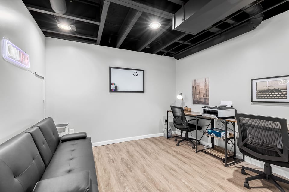 Private office with double desk workstations, printer, and futon