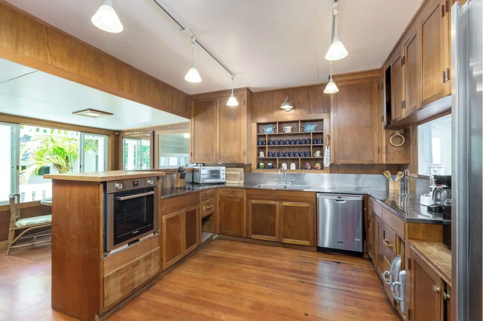Kitchen with two large refrigerators, breakfast table. 