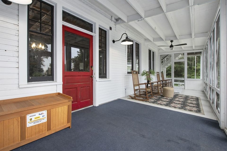 Enter Pine Lodge through the expansive front screen porch