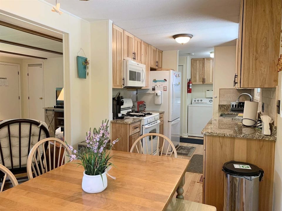 Kitchen has a range, microwave, Keurig, and toaster oven