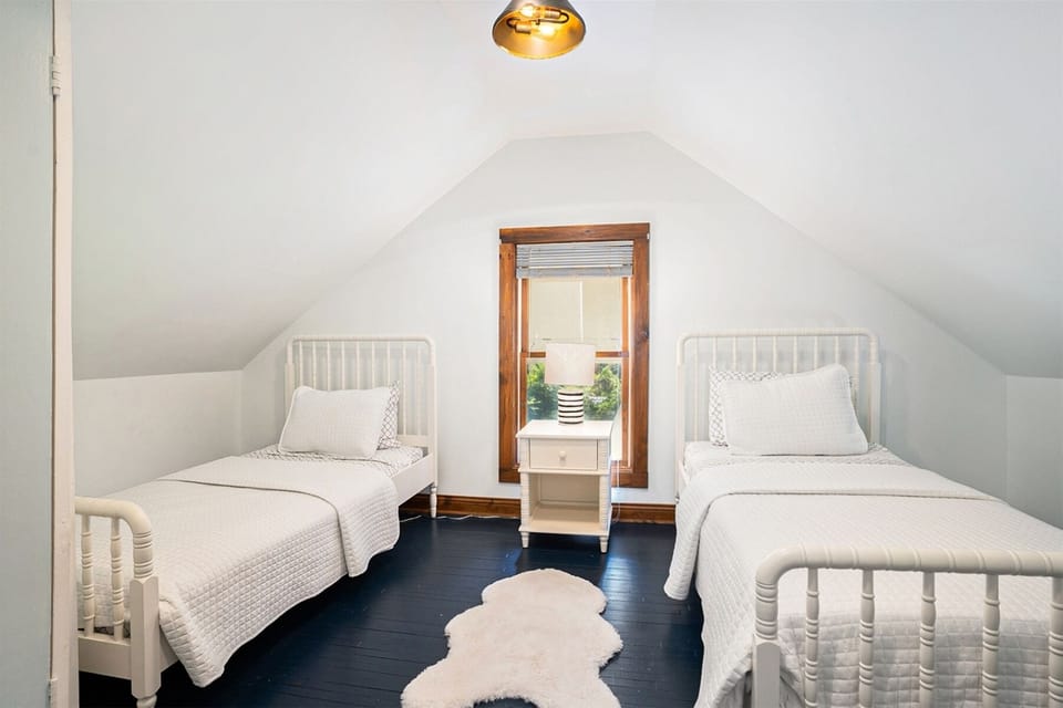 Upstairs walkthrough bedroom with two twin beds. You have to walk through this room to get to the other upstairs bedroom.