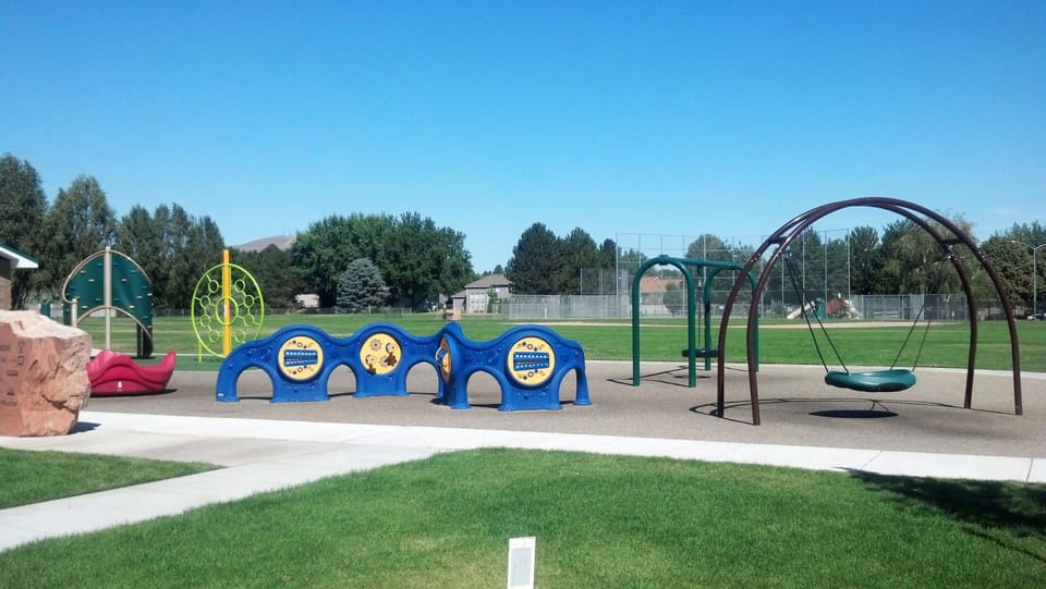 Let kids laugh freely at a sunny playground close by.